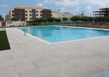 Piscina municipal desbordante con porcelánico Urban Gris de Gres Aragón en Nules.